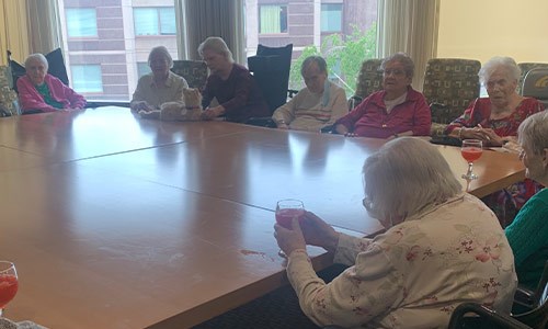 A group of seniors around a table at the Cabrini of Westchester